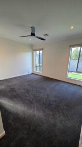 New charcoal carpet installed in a bedroom with large windows