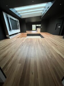 Blackbutt Engineered Timber Flooring in a dark feature room with skylights
