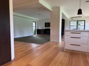 Timber flooring transitioning from kitchen to dining room