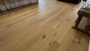 Engineered timber flooring running through an open plan kitchen and living area in Melbourne