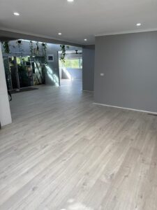 Light grey vinyl plank flooring through an open plan living area