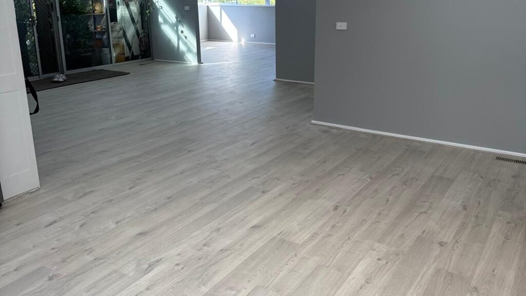 Light grey vinyl plank flooring through an open plan living area