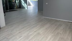 Light grey vinyl plank flooring through an open plan living area